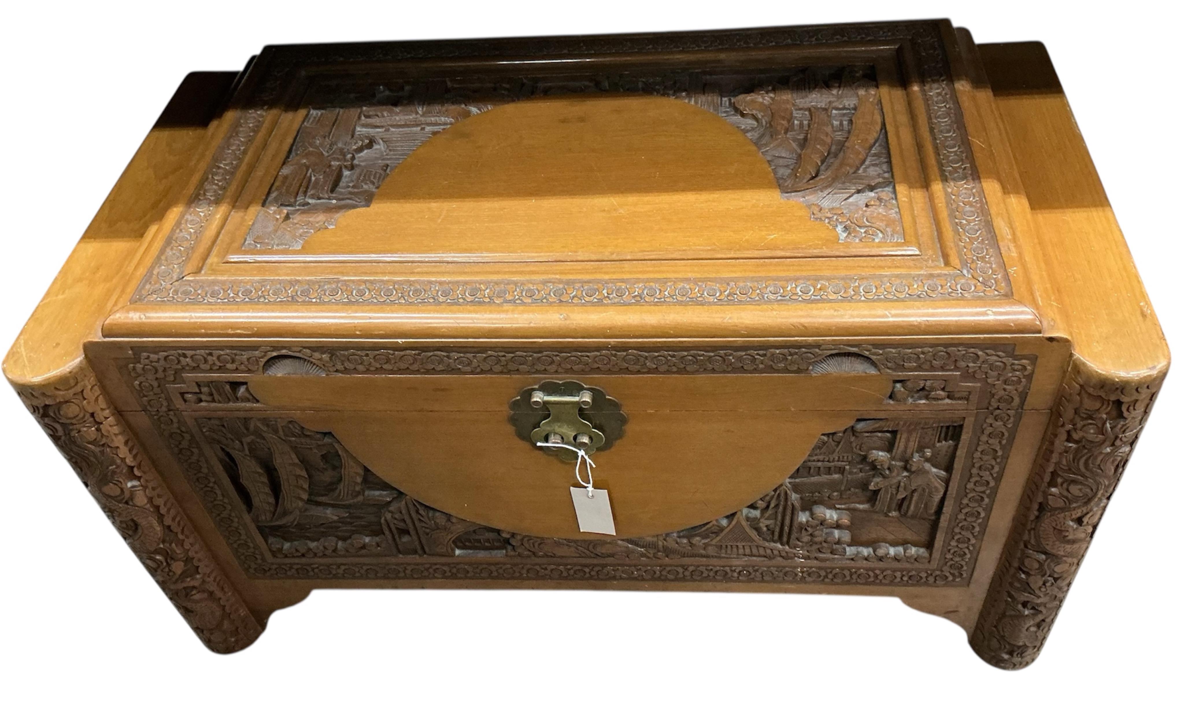 A Chinese carved camphorwood trunk, width 93cm, depth 50cm, height 49cm